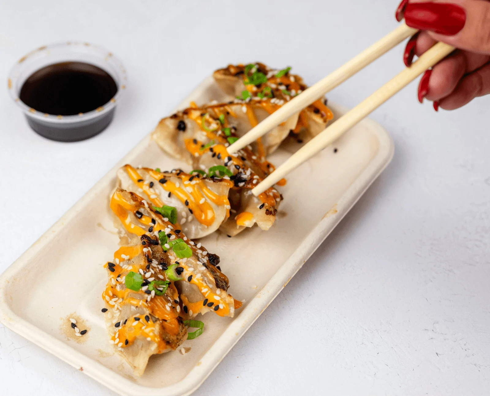 Wagyu Gyoza picked up with chopsticks at Shiso Crispy